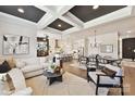 Spacious living room open to dining area and kitchen, featuring modern decor and dark coffered ceilings at 5055 Elm View Dr # 25, Charlotte, NC 28277