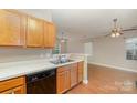 Galley kitchen with wood cabinets and modern appliances at 118 Camforth Dr, Mooresville, NC 28117