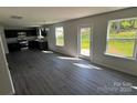 Open concept living space with dark cabinets, stainless appliances, gray floors and natural light at 1313 Dodd St, Shelby, NC 28152