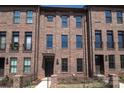 Beautiful brick townhome featuring detailed trim, a small balcony, and a well-manicured lawn at 222 Gilead Rd, Huntersville, NC 28078