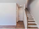Bright entryway with wood-look flooring and staircase with white risers and wood treads at 226 Gilead Rd, Huntersville, NC 28078