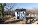 Rear view of two story house with white siding and sliding glass door at 2707 Crescent Ln, Gastonia, NC 28052