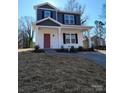 Two-story house with gray and white siding, red door, and small porch at 2707 Crescent Ln, Gastonia, NC 28052