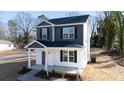 Two-story house with gray and white siding, red door, and small porch at 2707 Crescent Ln, Gastonia, NC 28052