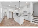 Open concept kitchen with white cabinets, large island, and stainless steel appliances at 1190 Lost Cove Rd, Indian Land, SC 29707