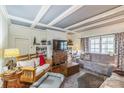 Cozy living room featuring a coffered ceiling, fireplace, and comfortable seating arrangement at 422 Lee Ave, Wadesboro, NC 28170