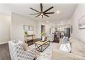 Open living room with hardwood floors, neutral decor, and a view into the kitchen at 9714 Ainslie Downs St, Charlotte, NC 28273