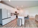 Modern kitchen with white cabinets, stainless steel appliances, and an island at 102 Guardian Gate Dr, Mooresville, NC 28115