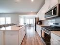 Modern kitchen with white cabinets, stainless steel appliances, and an island at 102 Guardian Gate Dr, Mooresville, NC 28115