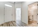 Bright foyer with wood-look flooring, leading to a bathroom and living space at 12320 Riceland Way, Midland, NC 28107