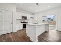 Modern kitchen with white cabinets, stainless steel appliances, and island at 731 Olde England Dr, Lincolnton, NC 28092
