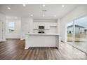 Modern kitchen with white cabinets, stainless steel appliances, and island at 731 Olde England Dr, Lincolnton, NC 28092