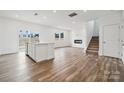 Open living area with hardwood floors, fireplace, and kitchen island at 731 Olde England Dr, Lincolnton, NC 28092
