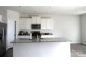 Modern kitchen with white cabinets, granite countertops, and stainless steel appliances at 1109 Creedmore Ct, Charlotte, NC 28215