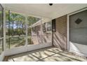 View of the screened-in porch that features views of the beautiful surrounding greenery at 1725 Feature Rd, Lancaster, SC 29720