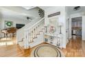 Bright foyer with a staircase, hardwood floors, decorative accents, and a neutral color scheme, creating a welcoming atmosphere at 5300 Green Rea Rd, Charlotte, NC 28226