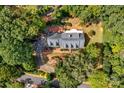 House nestled in a wooded lot with a large driveway at 118 Cramer Mountain Woods Rd, Cramerton, NC 28032