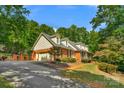 Brick home with a two-car garage and mature trees at 118 Cramer Mountain Woods Rd, Cramerton, NC 28032