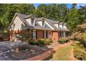 Brick home with a two-car garage and landscaped yard at 118 Cramer Mountain Woods Rd, Cramerton, NC 28032