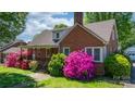 Quaint brick home with beautiful landscaping and a cozy covered porch at 112 S 2Nd Ave, Maiden, NC 28650