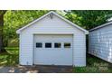 Detached one car garage with white siding and paneled door at 112 S 2Nd Ave, Maiden, NC 28650