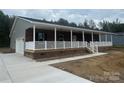 Attractive home with brick and gray siding, featuring a wide covered porch and an attached two-car garage at 745 Grier St, Rock Hill, SC 29730