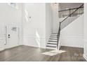 Bright living room featuring hardwood floors, high ceilings, and a staircase at 5108 Silver Creek Ln, Denver, NC 28037