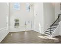 Bright living room featuring hardwood floors, high ceilings, and a staircase at 5108 Silver Creek Ln, Denver, NC 28037