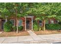 Brick townhouse with landscaping and a walkway at 1002 Tj Dr, Monroe, NC 28112