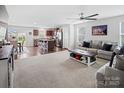 Spacious open-concept living room flowing into kitchen, featuring modern decor, plenty of natural light, and stylish furnishings at 4280 Stream Dale Cir, Concord, NC 28027