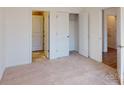 Simple bedroom with carpet, a closet, and access to a bathroom at 1805 Augustine St, Monroe, NC 28112