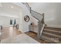 Bright entryway with a staircase, wood floors, and a view into the dining area at 116 Brooke Forest Ct, Mooresville, NC 28115