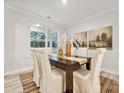 Casual dining area with a dark wood table and six beige chairs at 223 E Warfield Dr, Mooresville, NC 28115