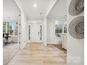 Light-filled entryway showcasing hardwood floors and a white front door at 223 E Warfield Dr, Mooresville, NC 28115