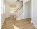 Hardwood floor entryway with staircase and view to living area at 10505 Boudreaux St, Huntersville, NC 28078