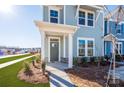 Townhome's front entrance with a gray door and stone accents at 10505 Boudreaux St, Huntersville, NC 28078