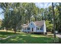 Cute blue house with a wooden deck and well-manicured lawn at 200 Cleveland Ave, Shelby, NC 28150