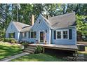 Inviting light blue house with a large deck and landscaping at 200 Cleveland Ave, Shelby, NC 28150