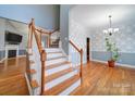 Open staircase with wooden railing and hardwood floors at 615 Real Quiet Ct, York, SC 29745