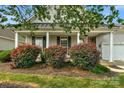 House exterior showcasing a covered front porch and neatly landscaped front yard at 2024 Holly Villa Cir, Indian Trail, NC 28079