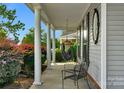 Relaxing front porch with a hammock and metal chairs, perfect for enjoying the outdoors at 2024 Holly Villa Cir, Indian Trail, NC 28079