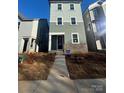 Modern three-story house with gray siding and a walkway at 207 Davidson Gateway Dr, Davidson, NC 28036