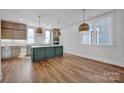 Modern kitchen with a large island and hardwood floors at 207 Davidson Gateway Dr, Davidson, NC 28036