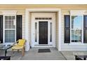 Inviting front entry with black door and yellow chair at 3015 Duclair Ln, Fort Mill, SC 29707