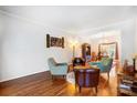 Cozy living room with hardwood floors and four comfortable chairs, flowing into the dining area at 138 Huntly Ln, Mooresville, NC 28115