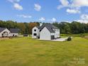 View of the home's side elevation showcasing a large backyard at 2109 Goose Creek Farm Ln, Indian Trail, NC 28079