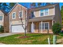 Two-story house with neutral siding, stone accents, and a two-car garage at 3308 Lemongrass Ln, Charlotte, NC 28214