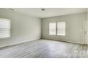 Spacious living room with gray vinyl plank flooring and neutral walls at 3308 Lemongrass Ln, Charlotte, NC 28214