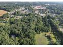 Aerial lot view showing a large, wooded area near a residential neighborhood at 1116 Medlin Rd, Monroe, NC 28112