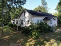 White single story home with a side view, showing the roofline and landscaping at 1116 Medlin Rd, Monroe, NC 28112